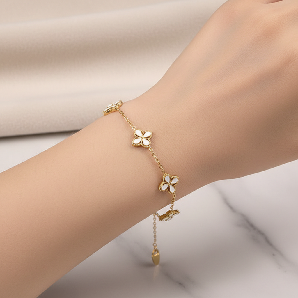 White enamel clover bracelet fitted on wrist
